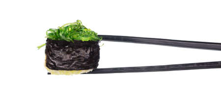 holding sushi by chopsticks isolated on white backgroundの写真素材