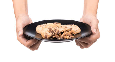 hand holding cookies Chocolate biscuits on dish isolated on white backgroundの写真素材