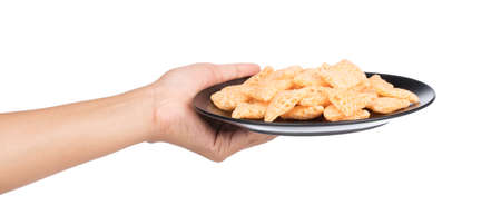 hand holding dish of snacks isolated on a white background