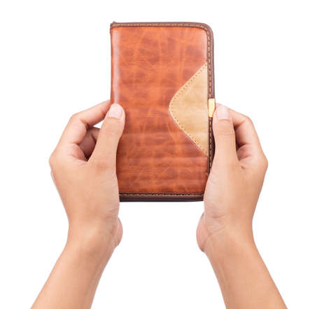 Hand holding notebook isolated on white backgroundの写真素材