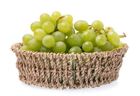 wicker basket of grape isolated on white backgroundの写真素材