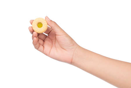 hand holding cookie with jam kiwi isolated on white background.の写真素材