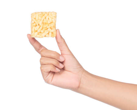 hand holding puffed rice isolated on a white background
