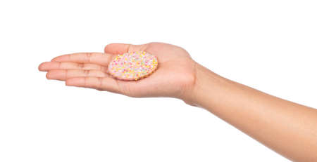 hand holding strawberry cookies with topping sprinkle isolated on white background.の写真素材