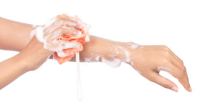 hand holding Soft orange bath puff or sponge isolated on white background