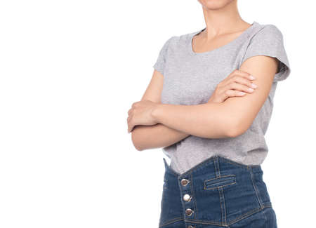 woman wearing blank gray t-shirt, jeans crossed arms isolated on white backgroundの写真素材