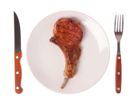 dish of Grilled pork ribs with fork and knife isolated on white backgroundの写真素材