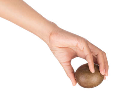 hand holding arhat fruit isolated on white backgroundの写真素材