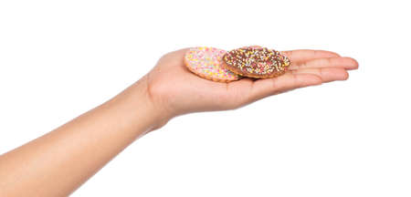 hand holding cookies with topping sprinkle isolated on white background.の写真素材