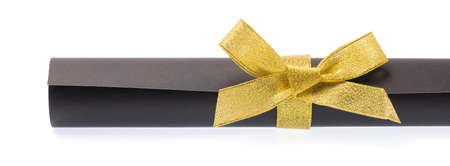 roll black paper with gold ribbon isolated on white backgroundの写真素材