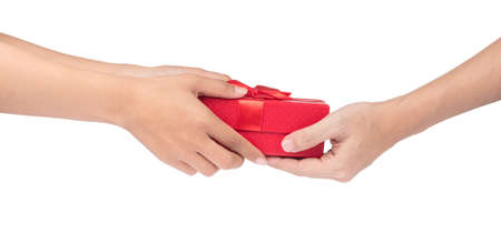 Hands giving and receiving a present isolated on white background