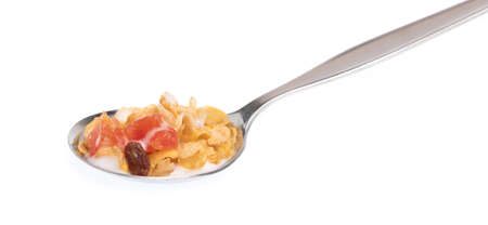 Cereal on spoon with milk isolated on white background.の写真素材