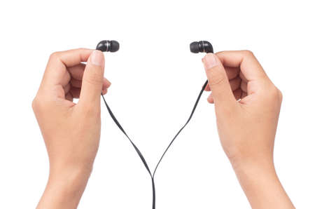 hand holding Earphones isolated on white backgroundの写真素材