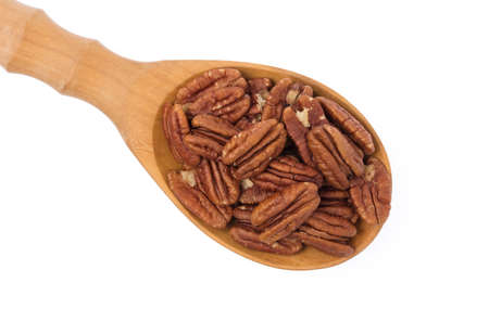 Pecan nut in ladle wooden isolated on white background
