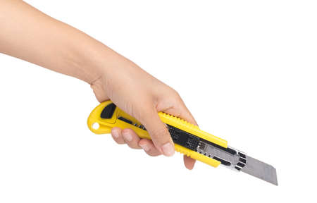 hand holding yellow cutter knife isolated on white background