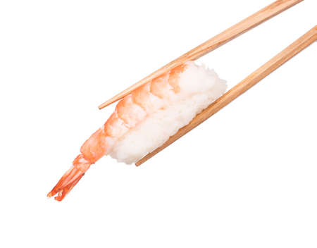 Hand holding sushi shrimp by chopsticks isolated on white backgroundの写真素材