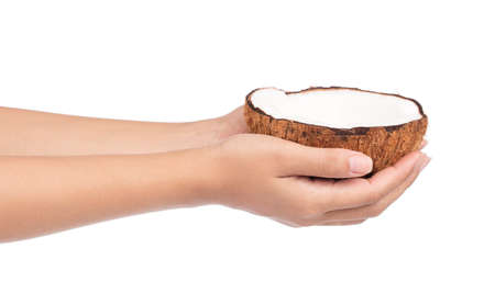 hand holding Coconut Old brown isolated on white backgroundの写真素材