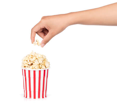 hand holding Popcorn in striped bucket isolated on white backgroundの写真素材