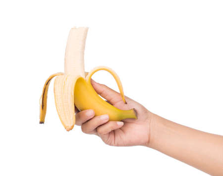 Hand peeling banana isolated on white background.の写真素材
