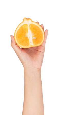 hand holding Half of orange isolated on white backgroundの写真素材