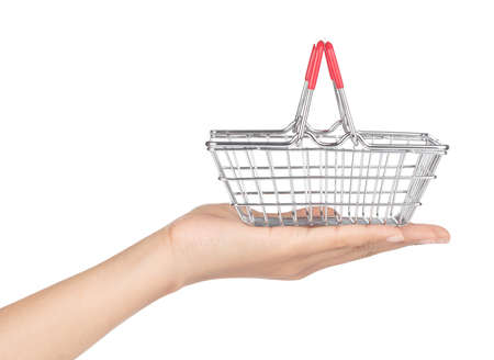 hand holding Chrome plated wire metal square empty shopping basket  isolated on white backgroundの写真素材