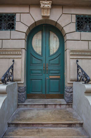 Green wooden door with brick wallの写真素材
