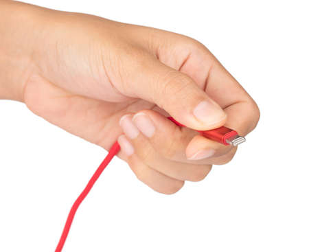 hand holding Red USB cable for smartphone isolated on white background.