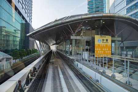 JAPAN - October 20, 2016: modern buildings with Scenic view of a train traveling on elevated rails of Yurikamome Line in Downtown Tokyoのeditorial素材