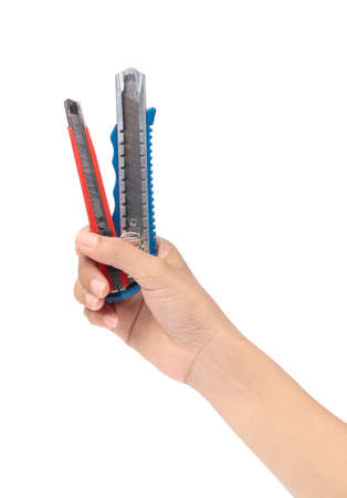 hand holding pair of blue and red cutters knife isolated on white background