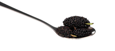 Mulberry on spoon isolated on white backgroundの写真素材