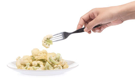 hand holding a fork with cauliflower isolated on white backgroundの写真素材