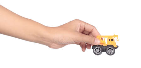 hand holding toy car isolated on white background