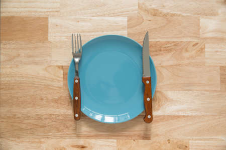 wood knife and fork with plate on wood background