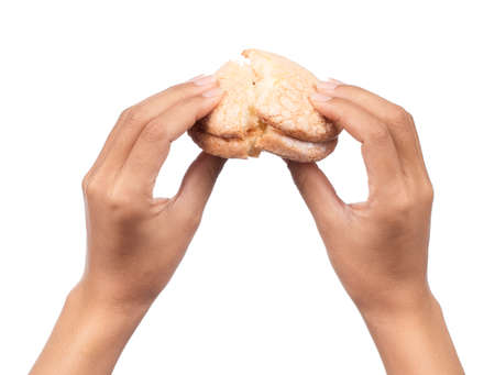 hand holding Vanilla cream biscuits isolated on white background.の写真素材