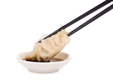 wontons with chopsticks isolated on white background.の写真素材