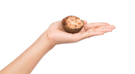 hand holding arhat fruit isolated on white background