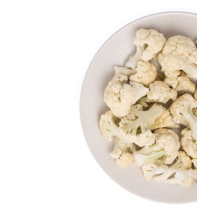 Pile of Cauliflower on plate isolated on white backgroundの写真素材