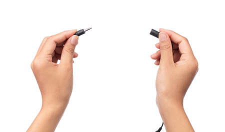 hand holding Audio Mini Jack Cable for microphone isolated on white background