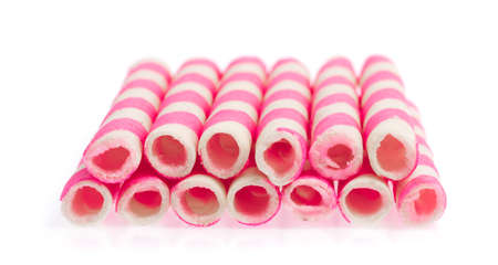 Striped wafer rolls filled with Strawberry isolated on white backgroundの写真素材