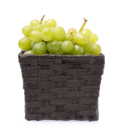 Bamboo basket of grape isolated on white backgroundの写真素材