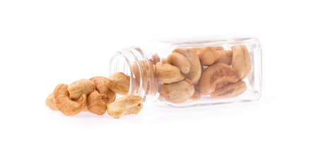 bottle of cashew nuts isolated on white backgroundの写真素材
