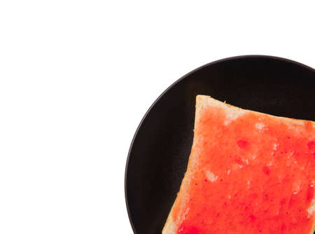 bread with strawberry jam on dish isolated on white background