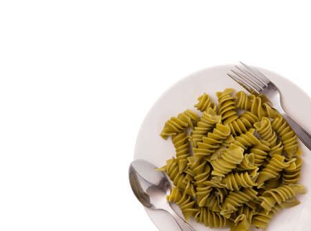 green pasta on dish isolated on white backgroundの写真素材