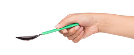 hand holding green spoon