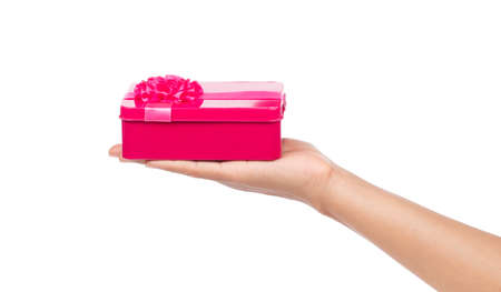 hand holding pink gift box isolated on white backgroundの写真素材
