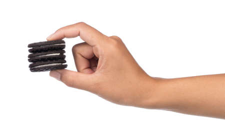 hand holding Oreo cookies with cream milk isolated on white backgroundの写真素材