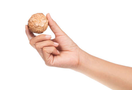 hand holding arhat fruit isolated on white backgroundの写真素材