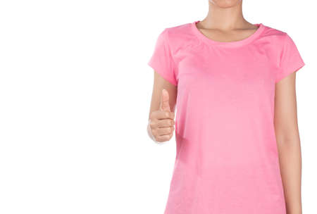 woman wearing blank pink t-shirt showing thumb up isolated on white backgroundの写真素材