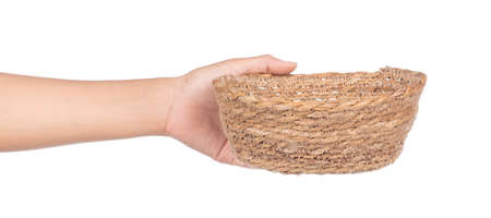 hand holding wicker basket isolated on white background
