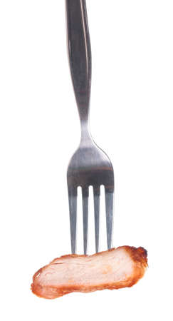 A grilled pork with fork isolated on white backgroundの写真素材